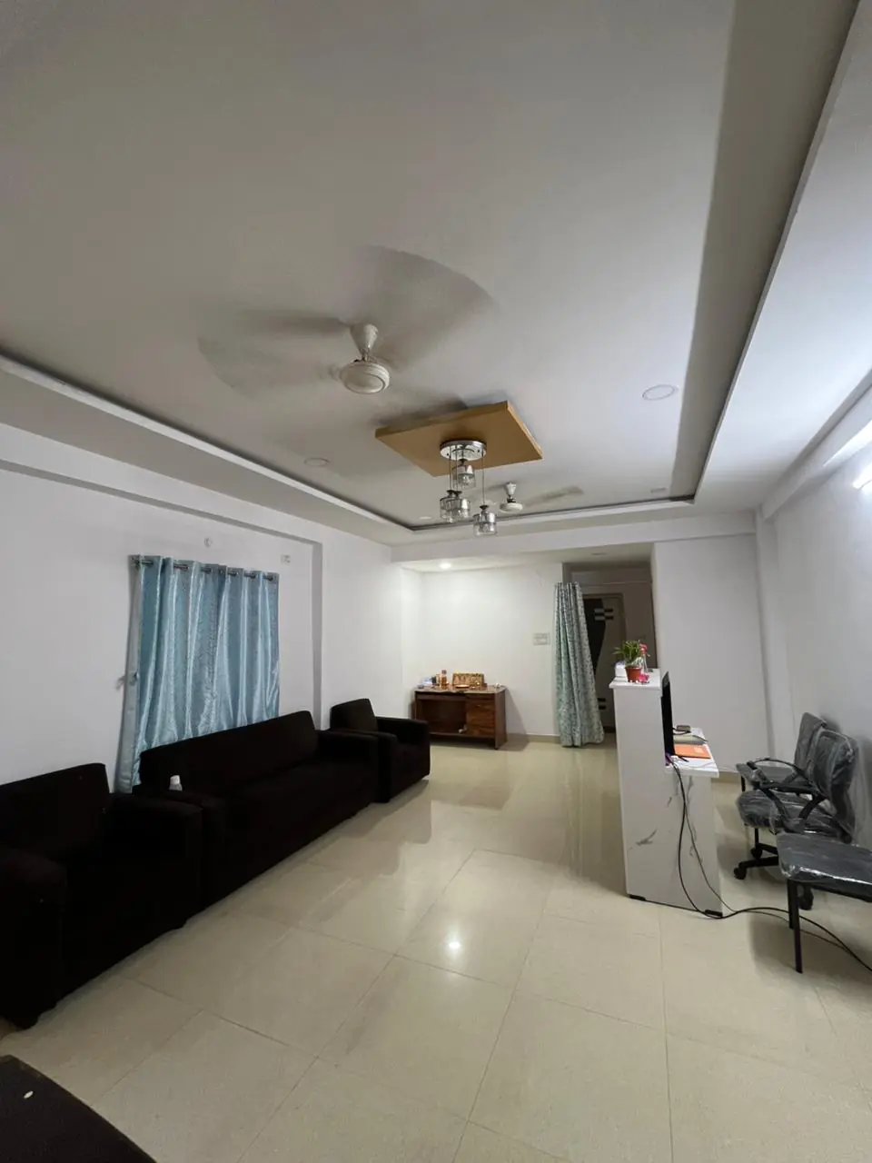 The reception and waiting area in daylight, with sofas and the front desk